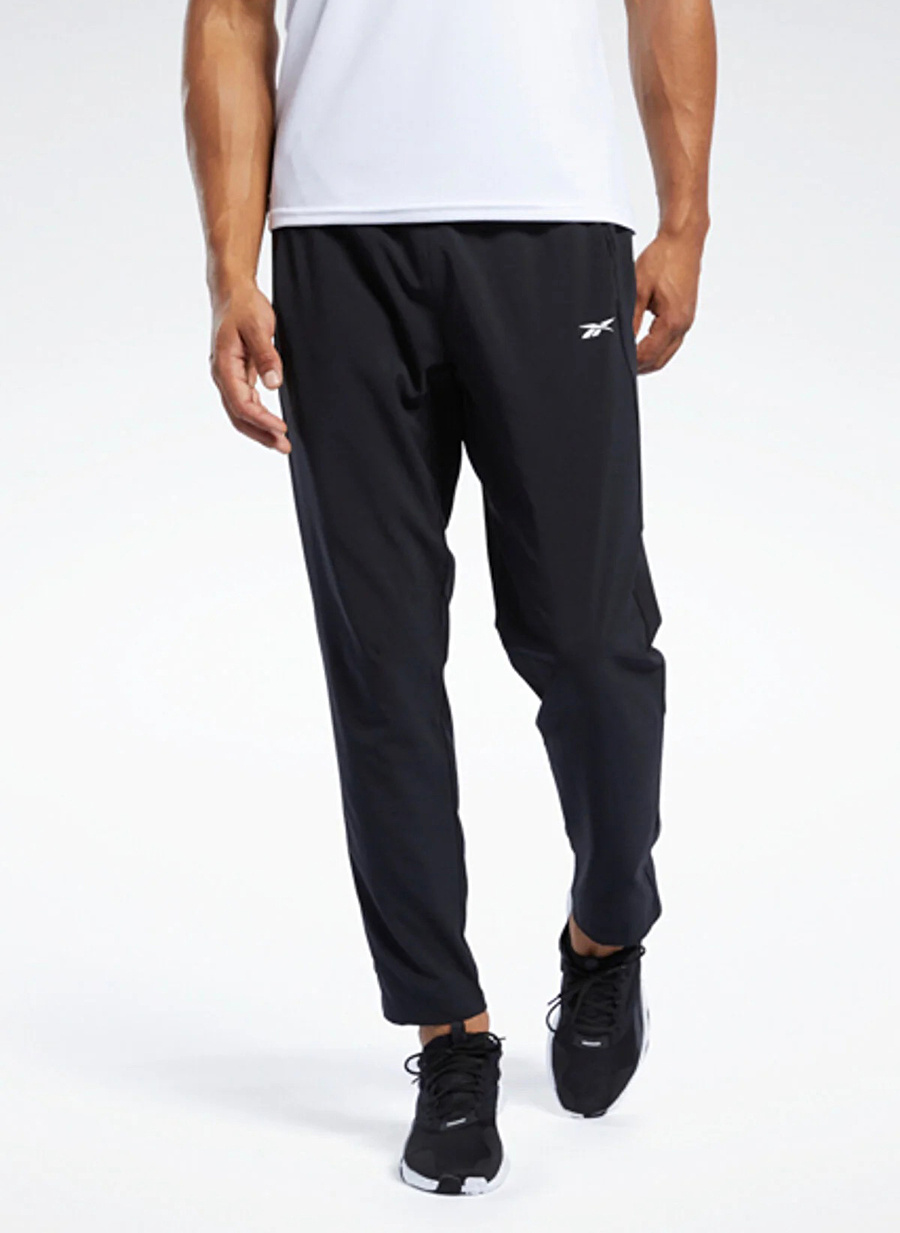 Reebok 100038337 WOR WOVEN PANT Siyah Erkek Standart fit Eşofman Altı